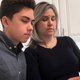 Grant Thompson and his mother, Michele, look at an iPhone in the family’s kitchen in Tucson, Arizona, on Thursday, Jan. 31, 2019.